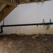 13 The black pipe was run underneath the deck against the wall and heading to the generator