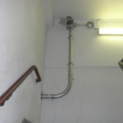 18 A stairwell pipe going to a camera wall bracket